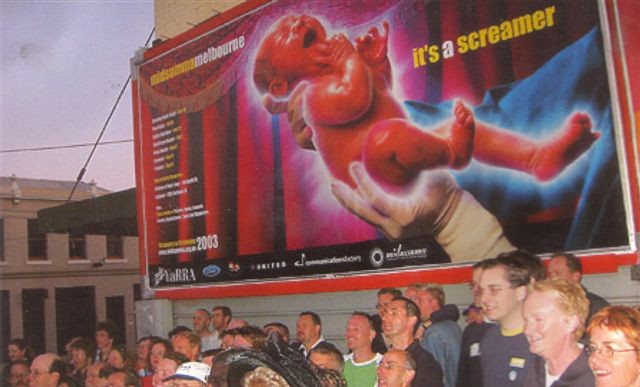 Crowd at 2003 history walk in front of Midsumma Festival billboard